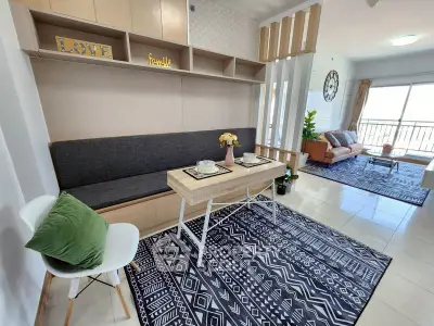 Modern living room with stylish decor and open layout, featuring cozy seating and natural light.