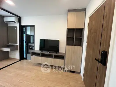 Modern living room with sleek wooden furniture and mounted TV