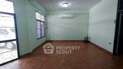 Spacious empty room with tiled floor and large windows, ideal for customization.