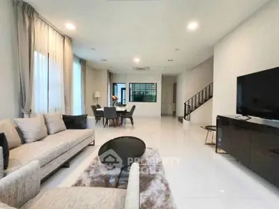 Spacious modern living room with elegant decor and open dining area