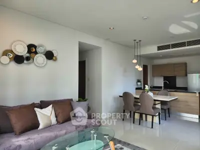 Modern open-plan living room and kitchen with stylish decor and dining area
