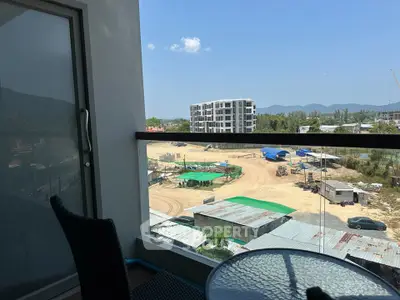 Scenic balcony view overlooking construction site and distant mountains
