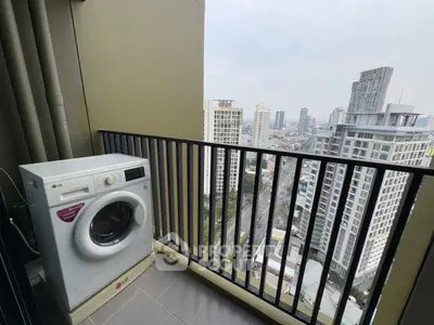High-rise balcony with city view and washing machine, perfect urban living.