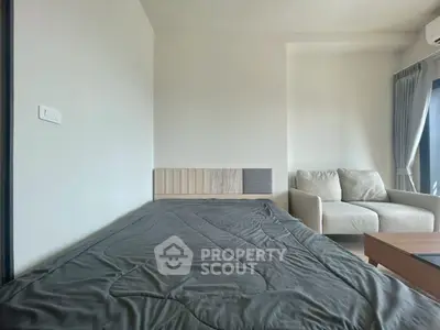 Modern bedroom with minimalist design and cozy seating area