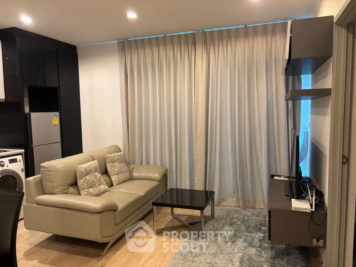 Modern living room with sleek furniture and cozy ambiance in a stylish apartment.