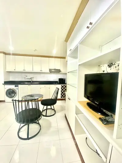 Modern kitchen with open layout, featuring sleek cabinets, dining area, and built-in appliances for stylish living.