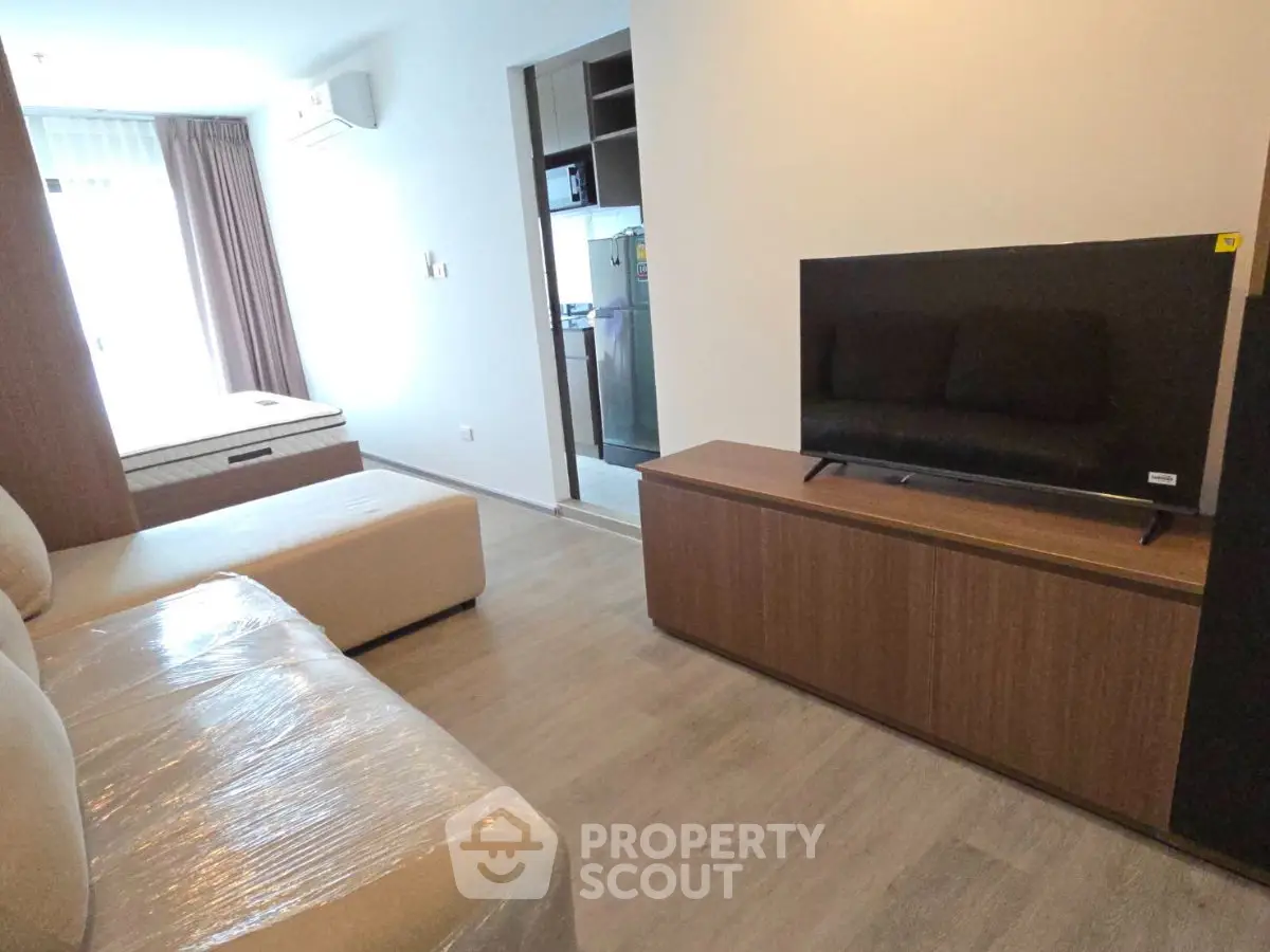Modern living room with sleek furniture and natural light in a contemporary apartment.