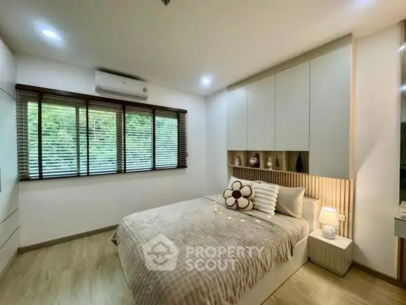 Cozy modern bedroom with stylish decor and natural light