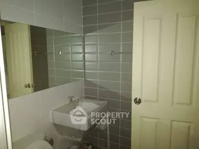 Modern bathroom with sleek gray tiles and a stylish sink, perfect for contemporary living.