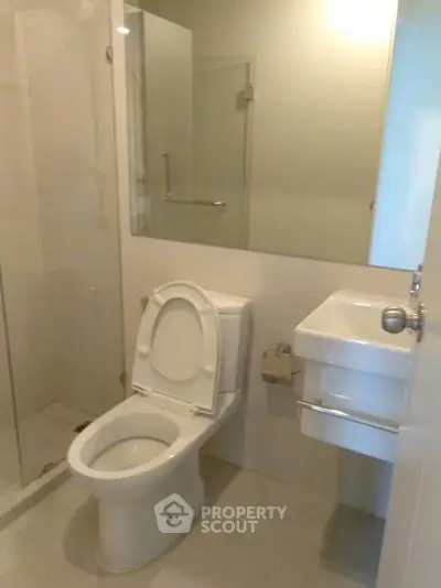 Modern bathroom with glass shower and sleek fixtures