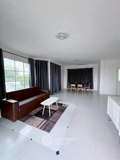 Spacious living room with modern furniture and large windows for natural light.