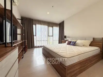 Spacious modern bedroom with large windows and stylish wooden furniture