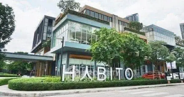 Modern commercial building with lush greenery and stylish architecture.