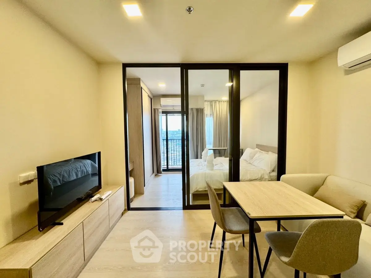 Modern apartment interior with cozy living area and bedroom view