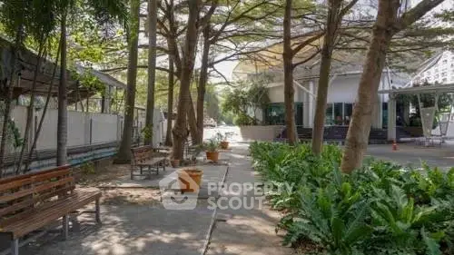 Charming outdoor garden area with lush greenery and seating, perfect for relaxation and leisure.