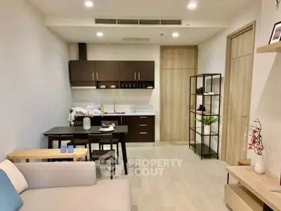 Modern open-layout living room with stylish kitchen and dining area