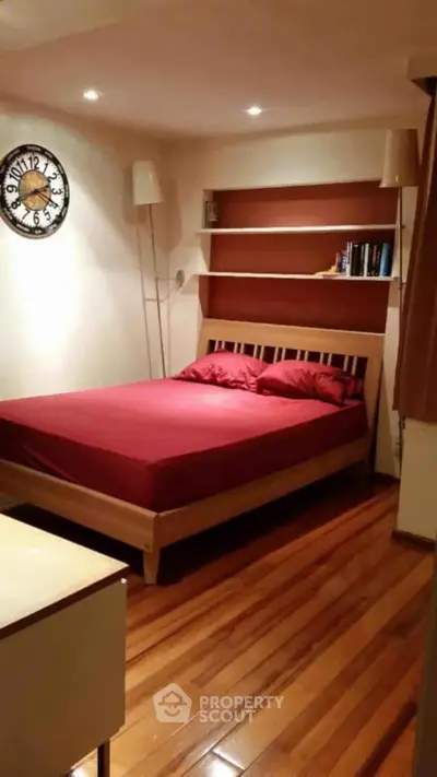 Cozy bedroom with wooden flooring and modern decor
