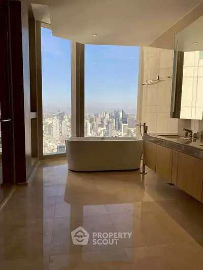 Luxurious bathroom with stunning city view and elegant bathtub in high-rise apartment.