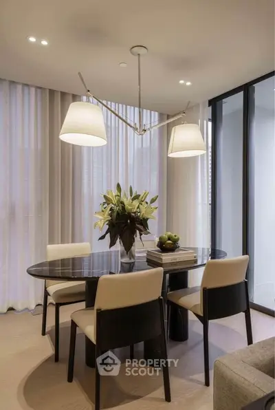 Elegant dining area with modern lighting and floor-to-ceiling windows in a stylish apartment.