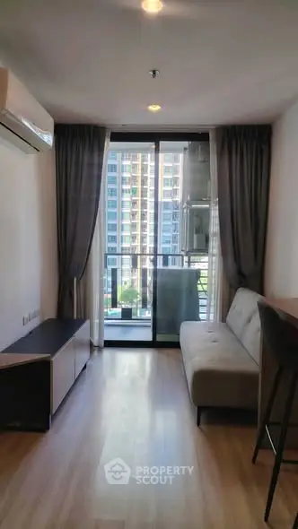 Modern living room with balcony view in high-rise apartment