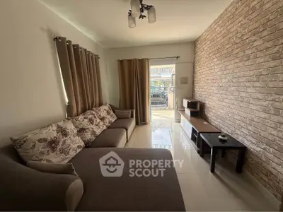 Spacious living room with modern decor and large windows for natural light.