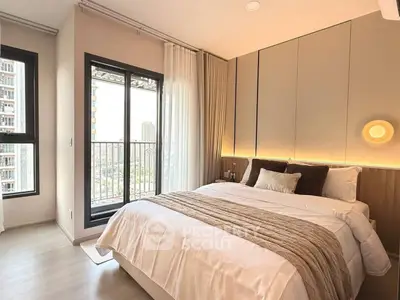 Modern bedroom with cozy lighting and balcony view in a stylish apartment.