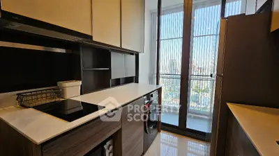 Modern kitchen with sleek design and stunning city view from large windows.