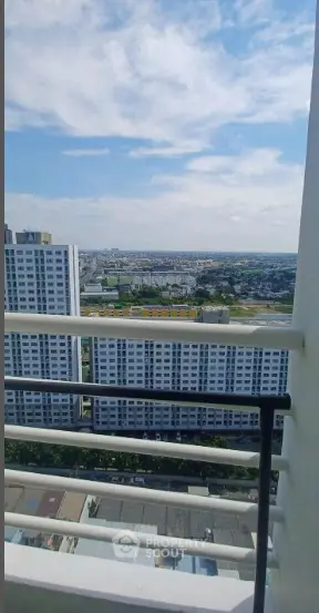Stunning high-rise balcony view overlooking cityscape and skyline, perfect for urban living.