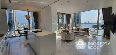 Luxurious open-plan living room with stunning city and river views, modern kitchen, and elegant decor.