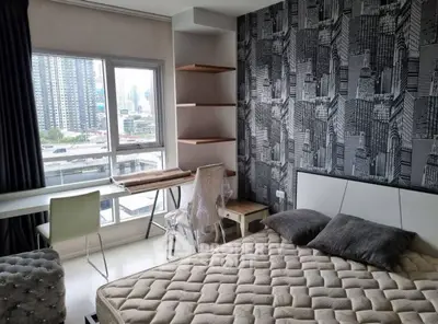Modern bedroom with city view, stylish wallpaper, and cozy furnishings.