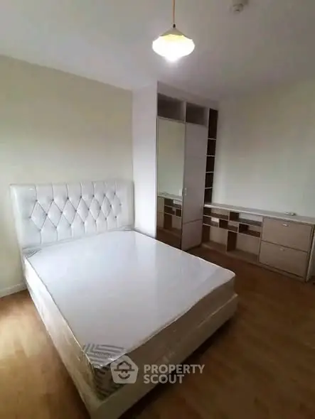 Spacious bedroom with elegant bed and ample storage in modern apartment