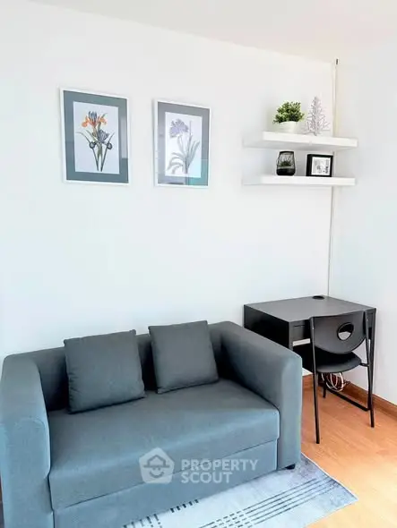 Modern living room with stylish sofa and wall art, perfect for cozy relaxation.