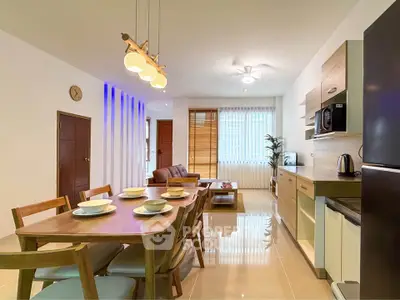 Modern open-plan living and dining area with stylish furniture and natural lighting.