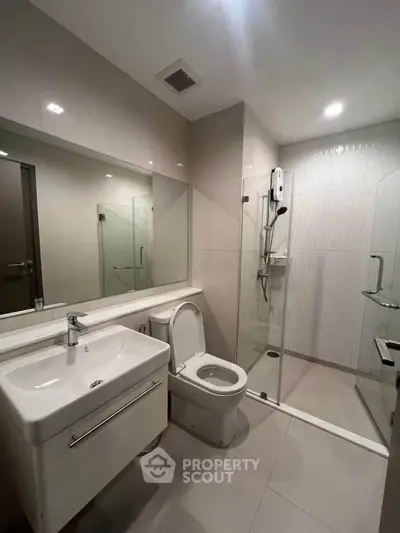 Modern bathroom with sleek fixtures and glass shower enclosure