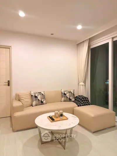 Modern living room with beige sofa and stylish decor in a cozy apartment.
