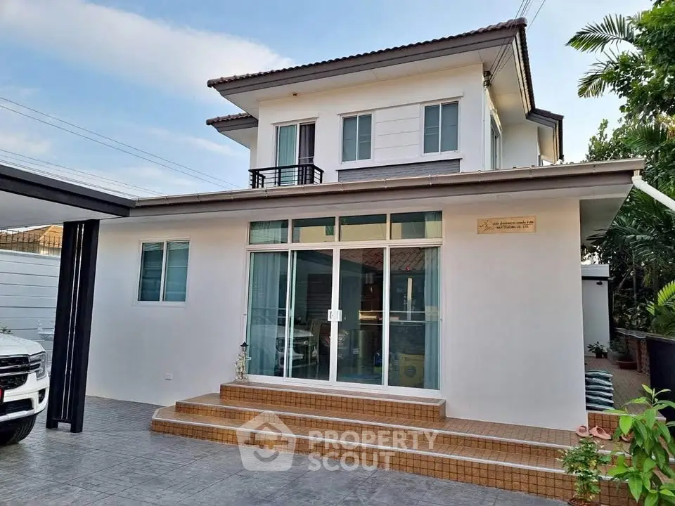 Charming two-story house with modern exterior and spacious driveway, perfect for family living.