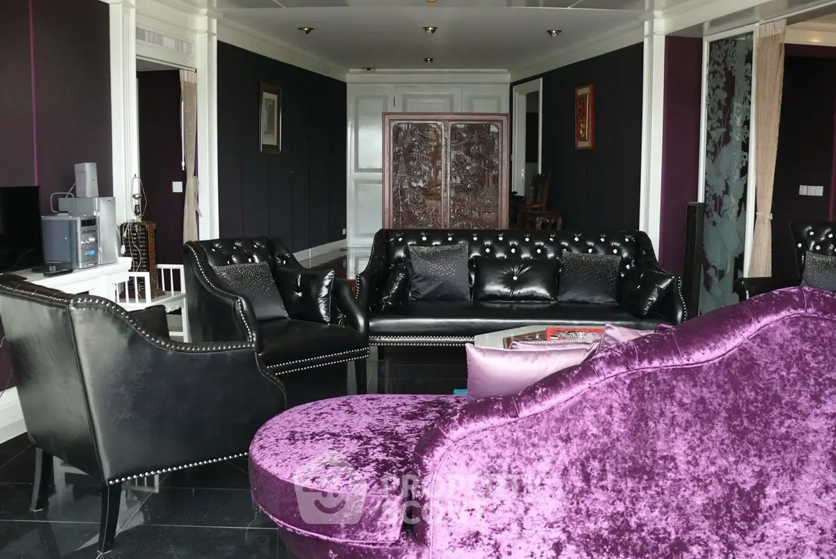 Luxurious living room with elegant black leather furniture and plush purple accents, perfect for sophisticated gatherings.