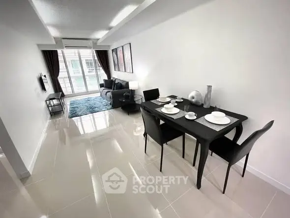 Modern living room with sleek dining area and natural light, perfect for urban living.