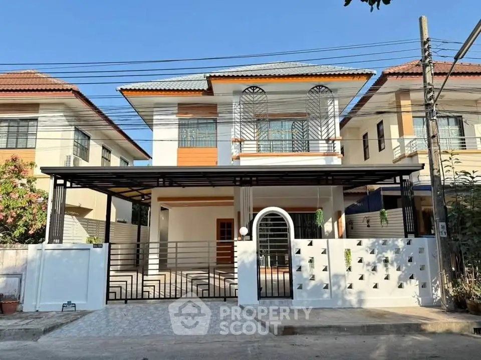 Modern two-story house with stylish facade and gated driveway in suburban neighborhood.