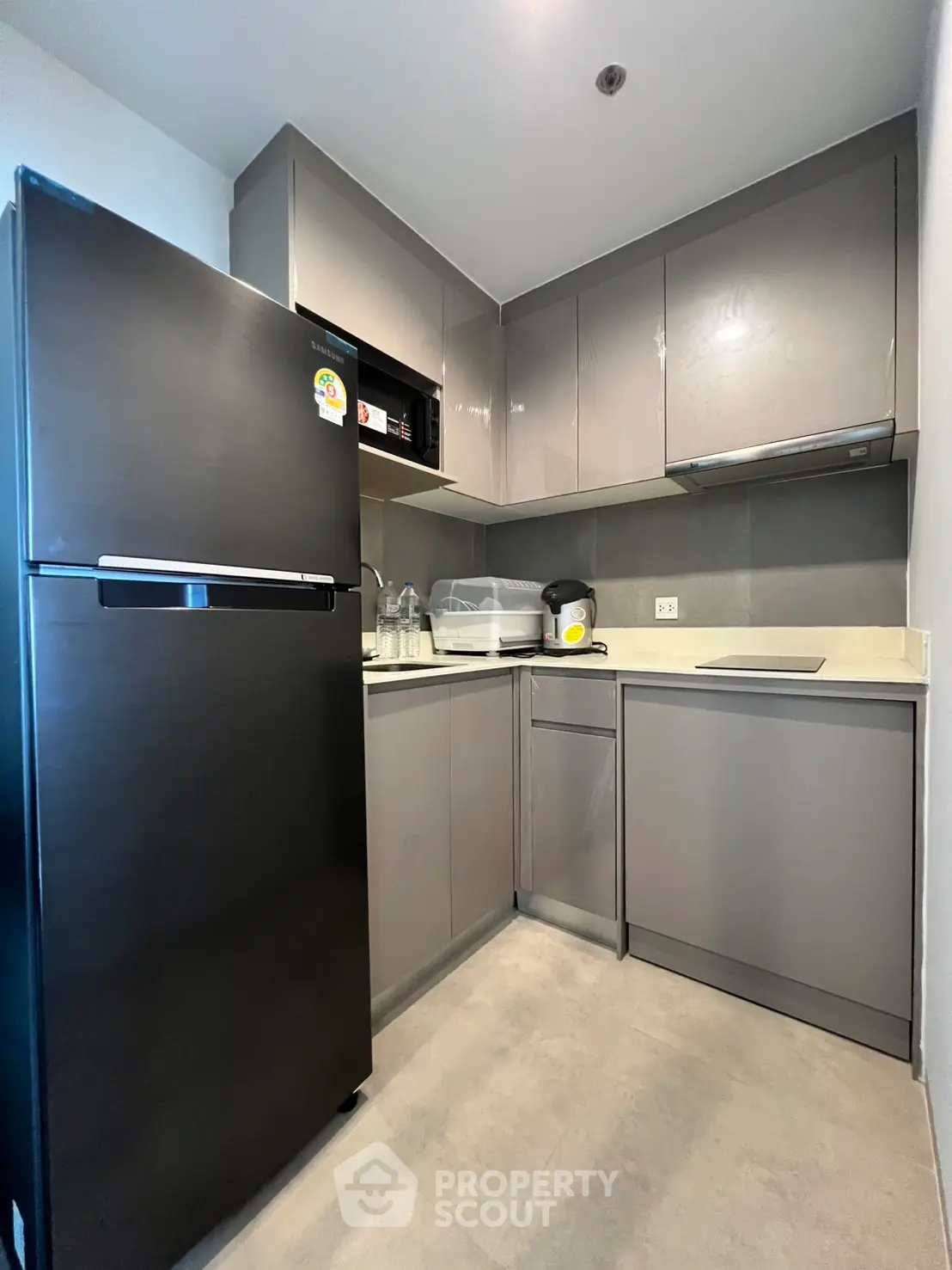 Modern kitchen with sleek cabinets and stainless steel appliances in a compact layout.