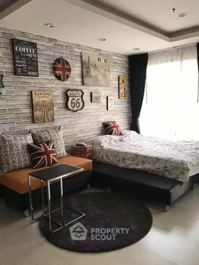 Chic urban bedroom with stylish decor and cozy seating area, perfect for modern living.