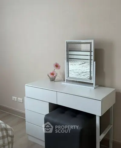 Modern bedroom with sleek white dresser and mirror, perfect for stylish living.