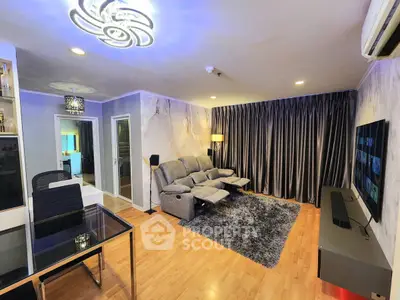 Modern living room with stylish lighting, plush seating, and sleek entertainment setup.