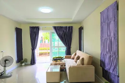 Spacious living room with modern decor and large windows for natural light.