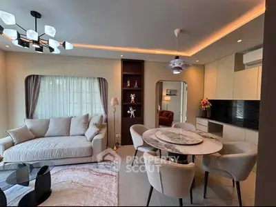 Modern living room with elegant dining area and stylish lighting in a contemporary apartment.