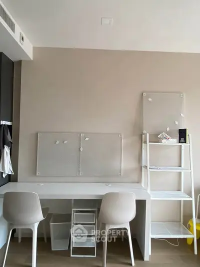 Modern study area with minimalist desk and chairs in a stylish apartment.