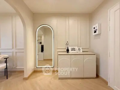 Elegant modern interior with stylish mirror and chic furniture in a bright living space.