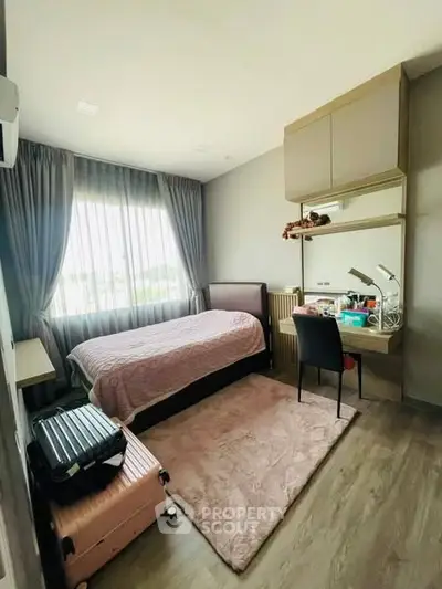 Cozy bedroom with modern decor and large window for natural light
