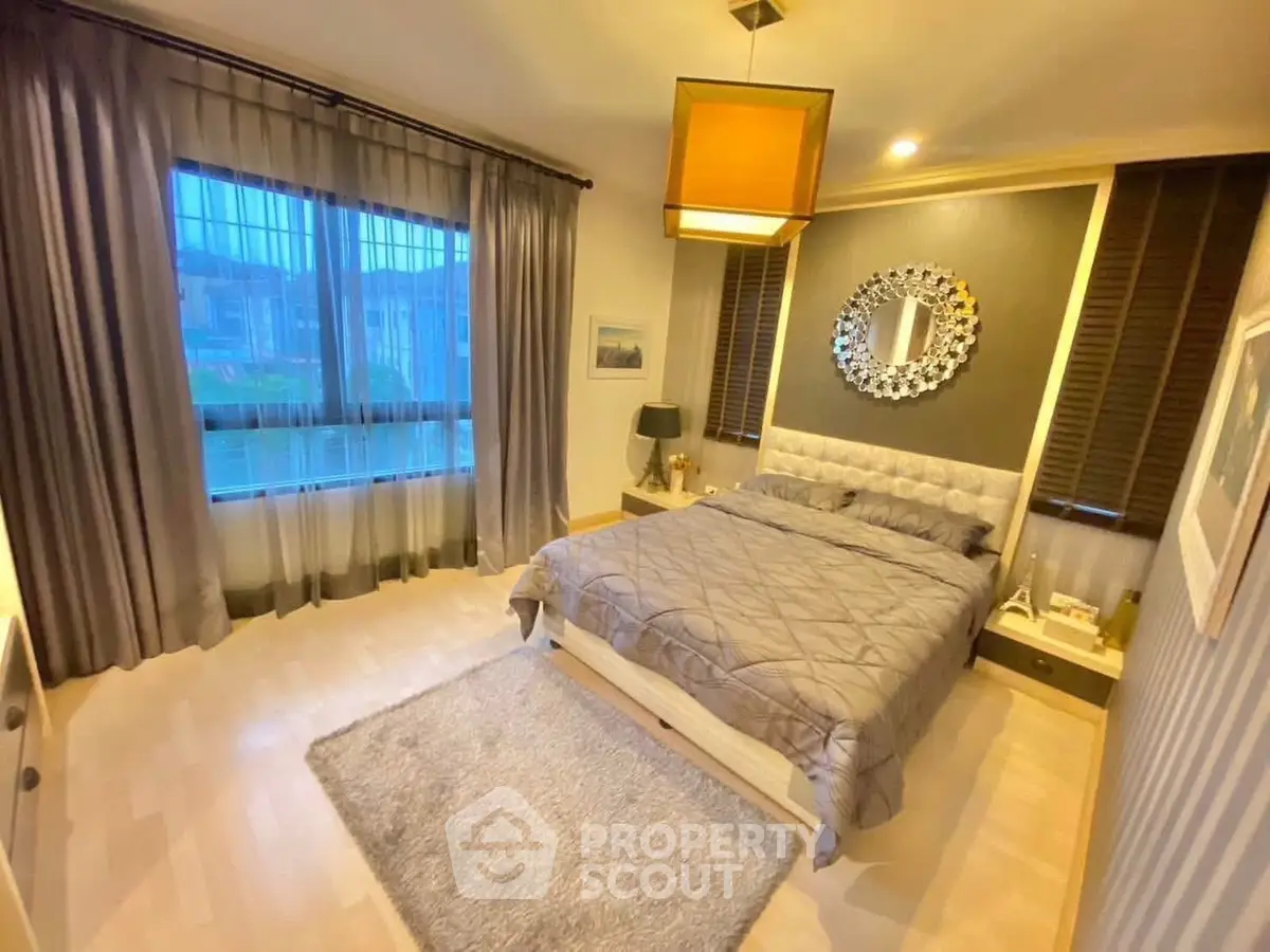 Elegant bedroom with modern decor and large window view