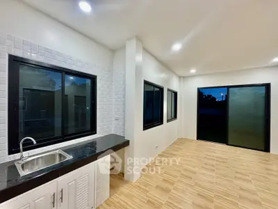 Spacious modern kitchen with sleek countertops and ample natural light